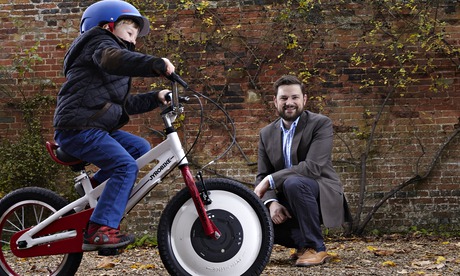 Robert Bodill watches  a young cyclist taking the Jyrobike for a spin.