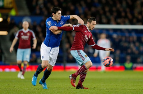 Morgan Amalfitano holds of Gareth Barry.
