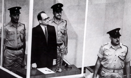 Eichmann in court showing no reaction when confronted with his terrible actions.