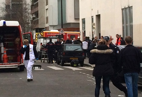 Firefighters and police in front of the Charlie Hebdo offices