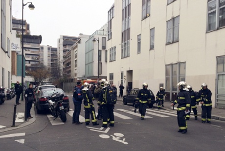 Police and firefighters outside the Charlie Hebdo offices in Paris.