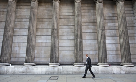 A man walking past the Bank of England