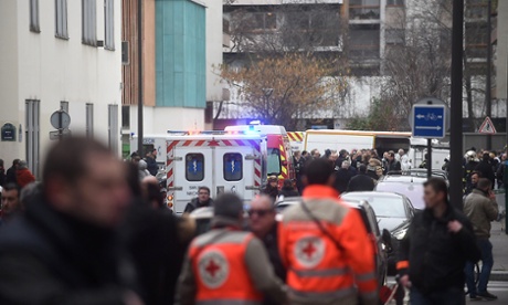 Ambulances and police officers in front of the offices of the French satirical newspaper Charlie Hebdo.