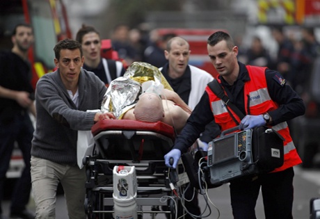 An injured person is evacuated from the Charlie Hebdo's office in Paris