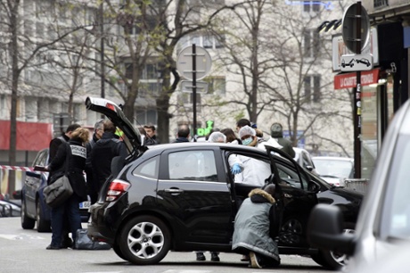 French police and forensic experts examine the car used by armed gunmen who stormed the Paris offices of Charlie Hebdo