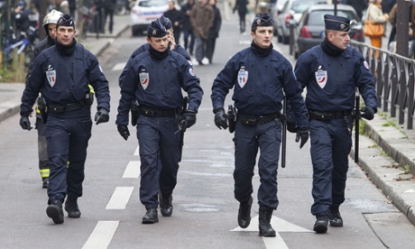 Police officers close to the offices of the French satirical newspaper Charlie Hebdo in Paris.