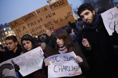 People hold Je Suis Charlie placards at the Place de la Republique