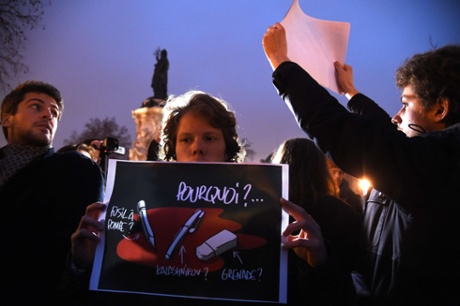 A man holds a placard reading 