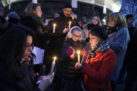 People light candles in support of the victims of the Charlie Hebdo attack at the Place de la Republique