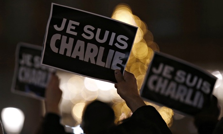Persons hold placards saying Je Suis Charlie - I am Charlie 