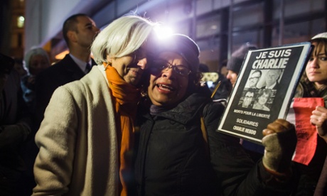 International Monetary Fund (IMF) Director Christine Lagarde (L) greets a participant in a vigil for the victims of the attack on the Paris offices of satirical magazine Charlie Hebdo outside the Newseum in Washington, DC, USA.
