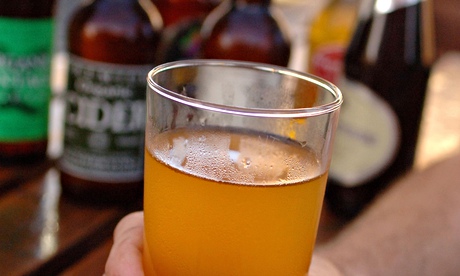 A man holding a pint of cider