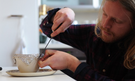 a man cutting the string on a steamed pudding