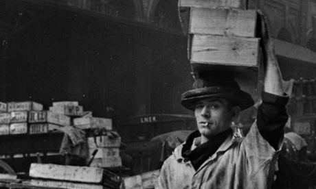 A porter at Billingsgate fish market in London, carries a load from the street into the market, April 1939.