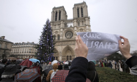 People hold signs reading 