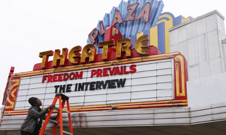 Cinema manager Brandon Delaney changing the marquis of the Plaza Theatre after the cinema announced it would show the controversial movie 'The Interview' in Atlanta, Georgia, USA.