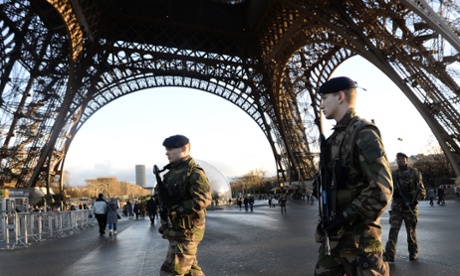 French soldiers patrol in front of the Eiffel Tower in Paris as the capital was placed under high alert