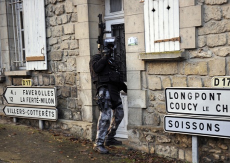 Members of the French police special force GIPN opens a door in Corcy, northern France, on January 8, 2015 during searches as part of an investigation into a deadly attack the day before by armed gunmen on the Paris offices of French satirical weekly Charlie Hebdo.