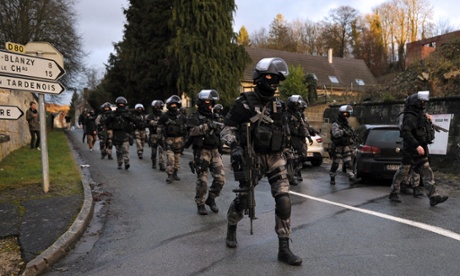 Members of the GIPN and RAID, French police special forces, walk in Corcy, northern France, on January 8, 2015.