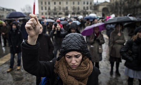 People gather for a minute's silence in front of Notre Dame cathedral in Paris