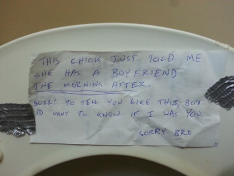 Handwritten note left on underside of a toilet seat