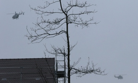 Two helicopters fly over Dammartin-en-Goele, where a major operation is underway for the suspects in the Charlie Hebdo shootings.