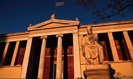 A Greek flag flutters on top Athens University, Greece