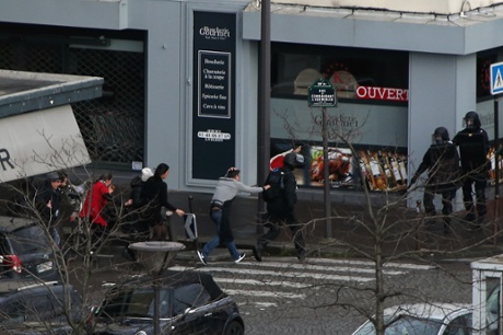 People are led away from the scene at a supermarket in Port de Vincennes