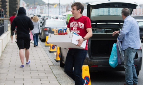 student carries box of possesions