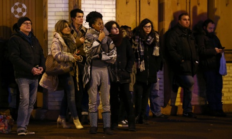 People watch on Avenue Joffre as police mobilise at the hostage situation in the supermarket
