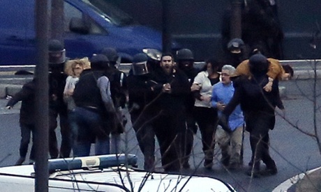 Members of the French police special forces evacuate the hostages after launching the assault at a kosher grocery store