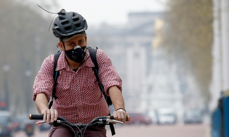 A cyclist wears a mask amid heavy smog in London.