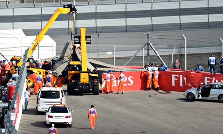 Medical crew attend to Toro Rosso driver Carlos Sainz Jr following his crash in practice
