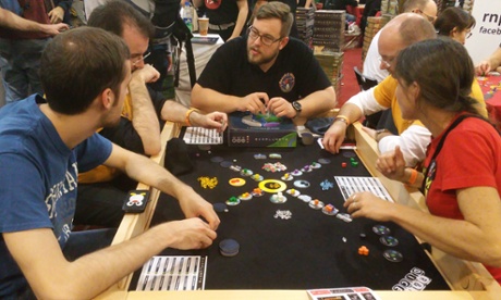 Gamers try out a board game at the annual Essen Spiel show in Germany