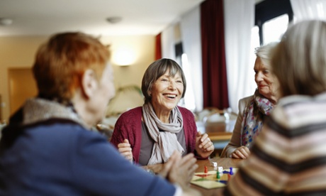 A group of elderly women laugh together