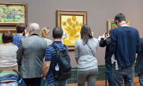 People look at paintings
