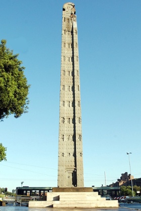 The 1,700-year-old Axum Obelisk, pictured against a clear, azure sky in a piazza in Rome, Italy