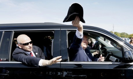Donald Trump throws a hat to a supporter in Waterloo, Iowa.