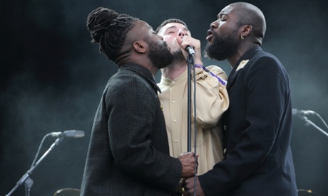 Kayus Bankole, Graham Hastings and Alloysious Massaquoi of Young Fathers perform on stage