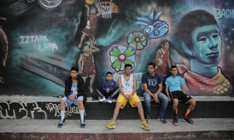 Boys rest during a break in a basketball match.