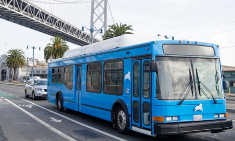 A Leap Transit bus drives passes under the Bay Bridge in San Francisco, California.