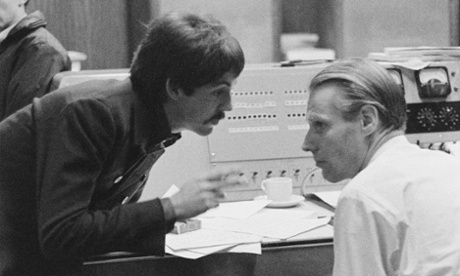 English singer, songwriter and musician Paul McCartney in a studio to record The Family Way November 1966. On the right is arranger and producer George Martin.