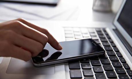 A person's laptop and mobile phone