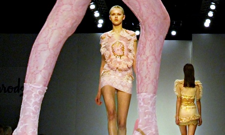 Models walk down the catwalk wearing clo