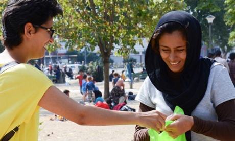 Volunteers distribute food and water