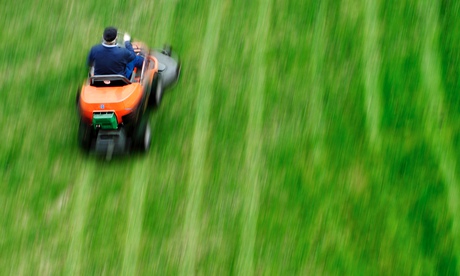A person driving lawn mower