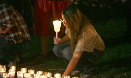 People attend a vigil for the victims of the Umpqua Community College mass shooting in Roseburg, Oregon.