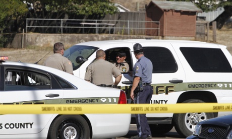 Sheriffs and police block the road that leads to the Umpqua Community College Shooting at Umpqua College, Roseburg, America.