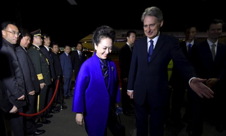 Peng Liyuan, wife of Chinese President Xi Jinping, escorted by Foreign Secretary Philip Hammond.