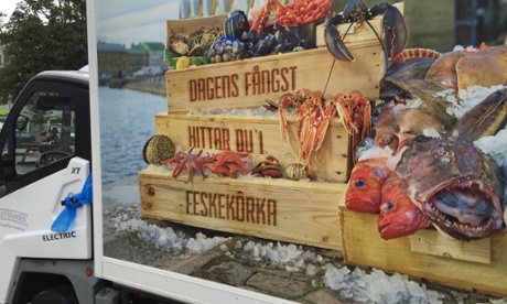 A small electric van transports fresh fish from harbour to market.